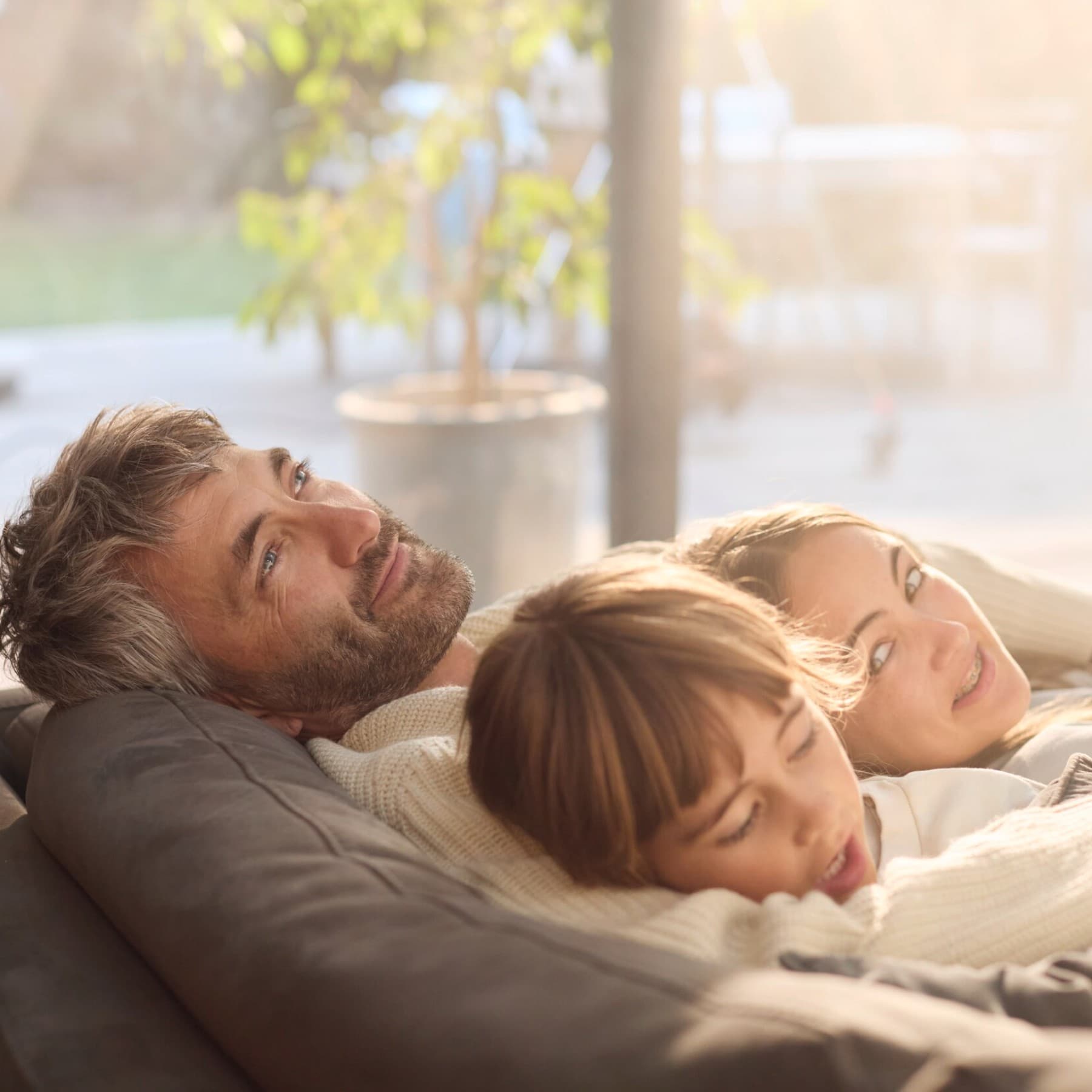 A family relaxing on a sofa in a living room
