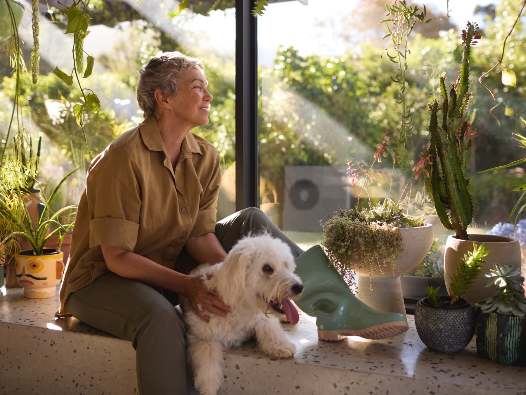 Woman sitting with her dog at the window