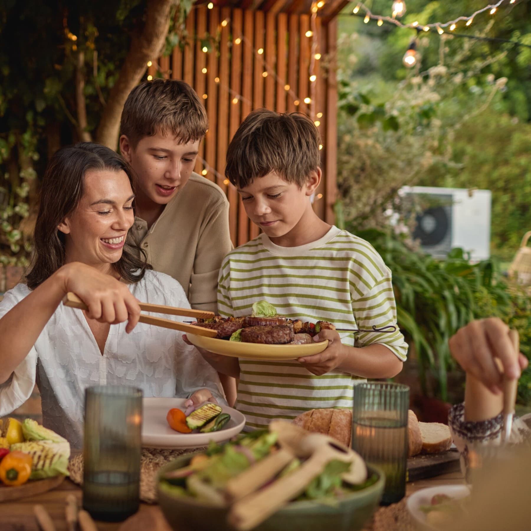 family having barbecue in garden